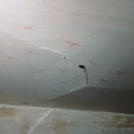 Severely deteriorated plaster is marked for removal and reattachment.