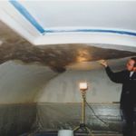 This area has received plaster infill following reattachment. Here Craig uses a sponge to touch up patch edges and match surface texture with original plaster.