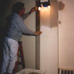 Peter softens the infill area with a damp sponge to further blend it into the original plaster.